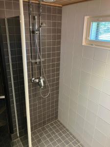 a shower in a bathroom with a glass door at Villa Fox Ruka in Ruka +23 photos