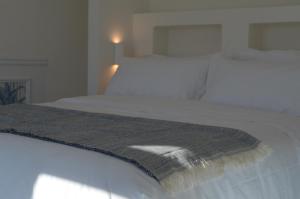 Postel nebo postele na pokoji v ubytování B&B Fuga al Trullo