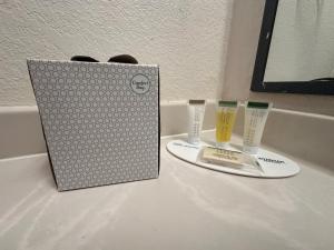 two toothbrushes and a box on a bathroom counter at Super 8 by Wyndham Richfield Cleveland in Richfield +43 photos