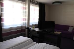 Postel nebo postele na pokoji v ubytování Amiga Hotel München Messe