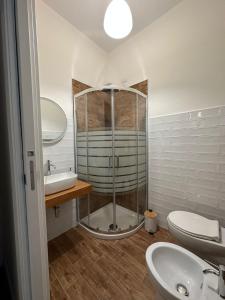 a bathroom with a shower and a sink and a toilet at Mavi Rooms in San Gavino Monreale +10 photos