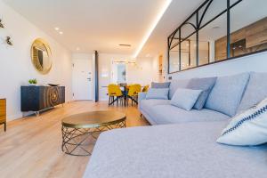 a living room with a couch and a table at Plaza España - Apartamentos Burgos Deluxe in Burgos +35 photos