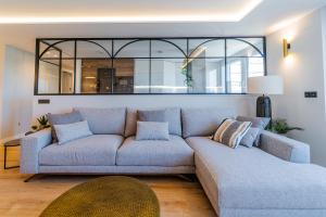 a living room with a couch and a table at Plaza España - Apartamentos Burgos Deluxe in Burgos