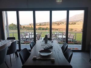 a table in a room with a view of a field at Zathay Apartments in Kamariotissa