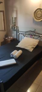 a bed with two pillows on top of it at Pool house Axiothea in Neméa +16 photos