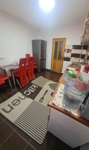 a room with red chairs and a table with a sign on it at Apartament Ania&Maria in Băile Herculane