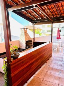 an outdoor entertaining area with a wood fence and a grill at Hostel Recanto da Paciência in Salvador