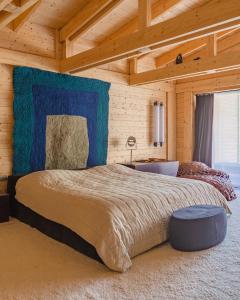 a bedroom with a large bed in a wooden room at Sami Mta Chalet in Mestia