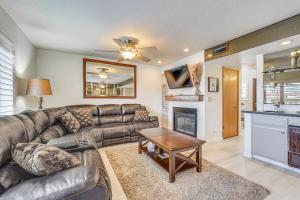 a living room with a leather couch and a fireplace at Walk to Lake Havasu Beaches Condo with Pool Access! in Lake Havasu City
