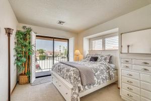 a bedroom with a bed and a large window at Walk to Lake Havasu Beaches Condo with Pool Access! in Lake Havasu City +33 photos