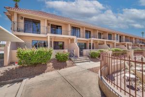 a building with a fence in front of it at Walk to Lake Havasu Beaches Condo with Pool Access! in Lake Havasu City