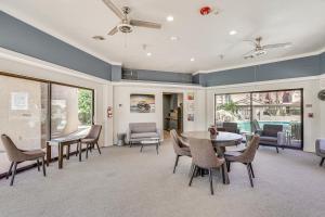 a living room with a table and chairs and a dining room at Walk to Lake Havasu Beaches Condo with Pool Access! in Lake Havasu City