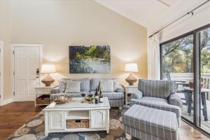 a living room with two couches and a table at 2319 Racquet Club in Hilton Head Island