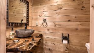 a bathroom with a stone sink on a wooden wall at Yellowstone Lodge in Blue Ridge +48 photos
