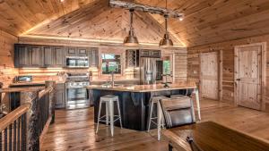 a kitchen with a large center island in a log cabin at Yellowstone Lodge in Blue Ridge