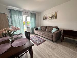 a living room with a couch and a table at Ośrodek Polny Kamyk in Wicie