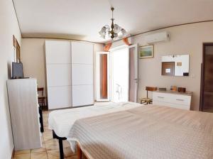 a bedroom with a large bed and a kitchen at Centralissimo Monolocale con Terrazzino Vista Mare in Leuca