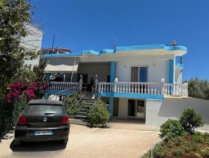 a car parked in front of a house at Angels Rooms in Ksamil