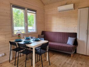 a living room with a table and a couch at Pastelowe Borne in Borne Sulinowo