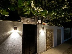 a pair of lights on the side of a wall at Vila Sofia in Eforie Nord