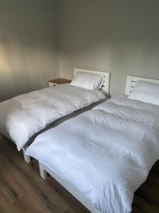 two beds sitting next to each other in a room at Killyfole lakeside lodges in Corranny