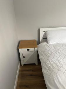 a bedroom with a bed and a nightstand next to a bed sidx sidx sidx at Killyfole lakeside lodges in Corranny