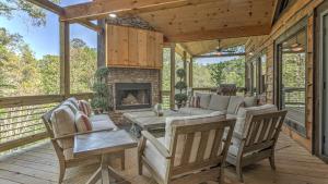 a living room with a couch and a fireplace on a deck at Friends in High Places in Blue Ridge