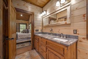 a bathroom with a double sink in a log cabin at Friends in High Places in Blue Ridge +54 photos
