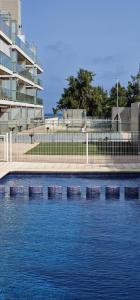 a pool of water in front of a building at Apartamento playa Moncofa-Chilches in Chilches