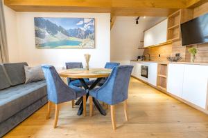 a kitchen and dining room with a table and chairs at Mountain Palace Tatra Resort & SPA in Kościelisko