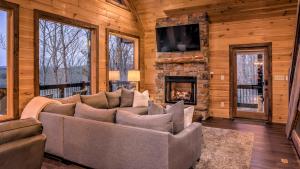 a living room with a couch and a fireplace at The Perfect Landing in Cherry Log