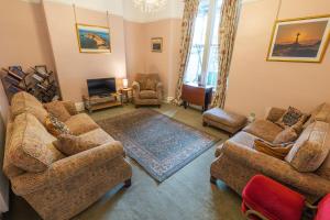 a living room with two couches and a tv at Isfryn Holiday Let in Caernarfon