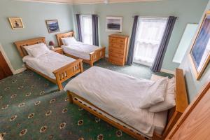 a bedroom with two beds in a room at Isfryn Holiday Let in Caernarfon +36 photos