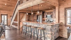 a kitchen with a stone bar in a log cabin at The Perfect Landing in Cherry Log