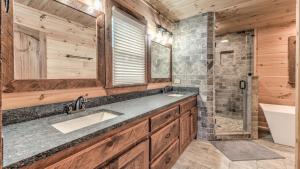 a bathroom with a sink and a shower and a tub at The Perfect Landing in Cherry Log +42 photos
