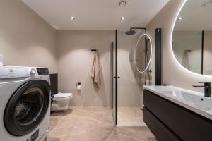 a bathroom with a washing machine and a sink at Modern Apartment close to Leknes in Leknes