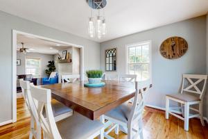 a dining room and living room with a wooden table and chairs at Storybook Escape in Weaverville