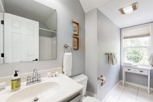a white bathroom with a sink and a mirror at Storybook Escape in Weaverville +19 photos