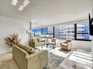 a living room with two couches and a glass table at Beach Resort condo 921 in Miami Beach