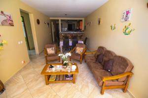 a living room with a couch and a table at vue sur la montagne in Pointe-Noire +8 photos