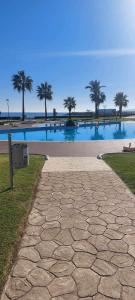 a large pool of water with palm trees in the background at Appartement Marina Beach, Mdiq in M'diq +19 photos
