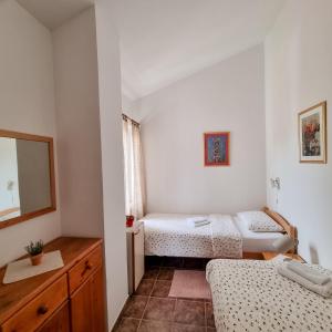 a small room with two beds and a mirror at Apartmani Senka in Vrsar