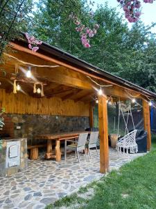 a pavilion with a table and chairs under it at Pensiunea Denisa Preda in Cheia +48 photos