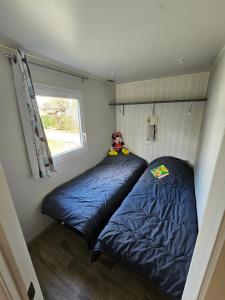 Postel nebo postele na pokoji v ubytování Camping Le Dolium