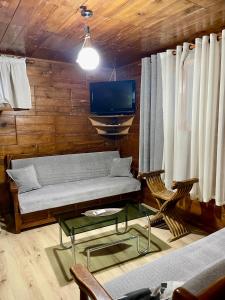 a living room with a couch and a tv at Guest House DEA in Vlorë