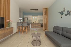 a living room with a couch and a table at Vasilis Modern Apartments in Alepou
