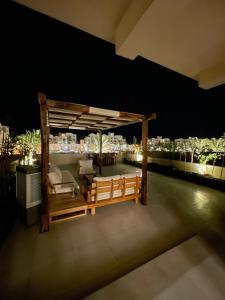 a rooftop deck with a pergola at night at ElGouna, Elegant 1Bedroom, private patio in Fanadir Marina in Hurghada