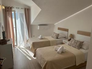 Postel nebo postele na pokoji v ubytování Apartmani Palada