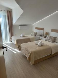 Postel nebo postele na pokoji v ubytování Apartmani Palada