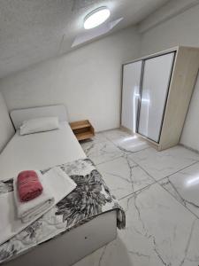 a bedroom with a bed and a large window at XXL APARTMENTS CiTY CENTAR in Bitola